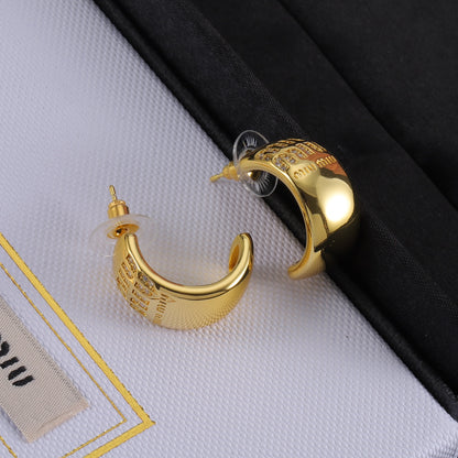 Gold glossy C-shaped hoop earring with logo front panel and stud detail