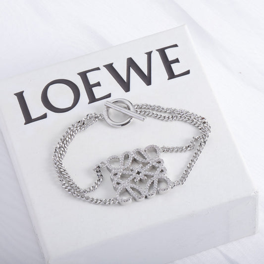 Silver openwork bracelet with chunky chain links, square-cutout charm and clasp