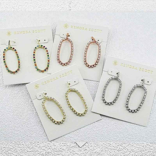 Assorted oval hoop earrings with zirconia pave, including multicolor and clear styles