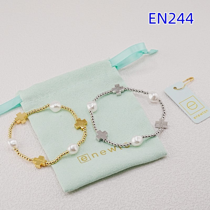 Pair of cross pearl beaded bracelets, gold and silver, with bar cross charms