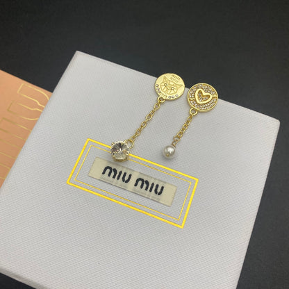 Gold asymmetrical diamond & pearl tassel earrings, heart and coin drop details