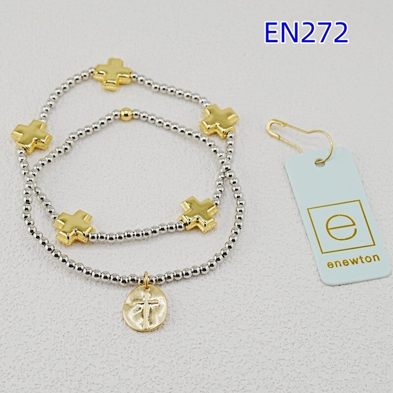 Two cross-charm beaded bracelets with gold accents, silver bead strands, coin pendant.