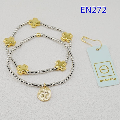 Two cross-charm beaded bracelets with gold accents, silver bead strands, coin pendant.