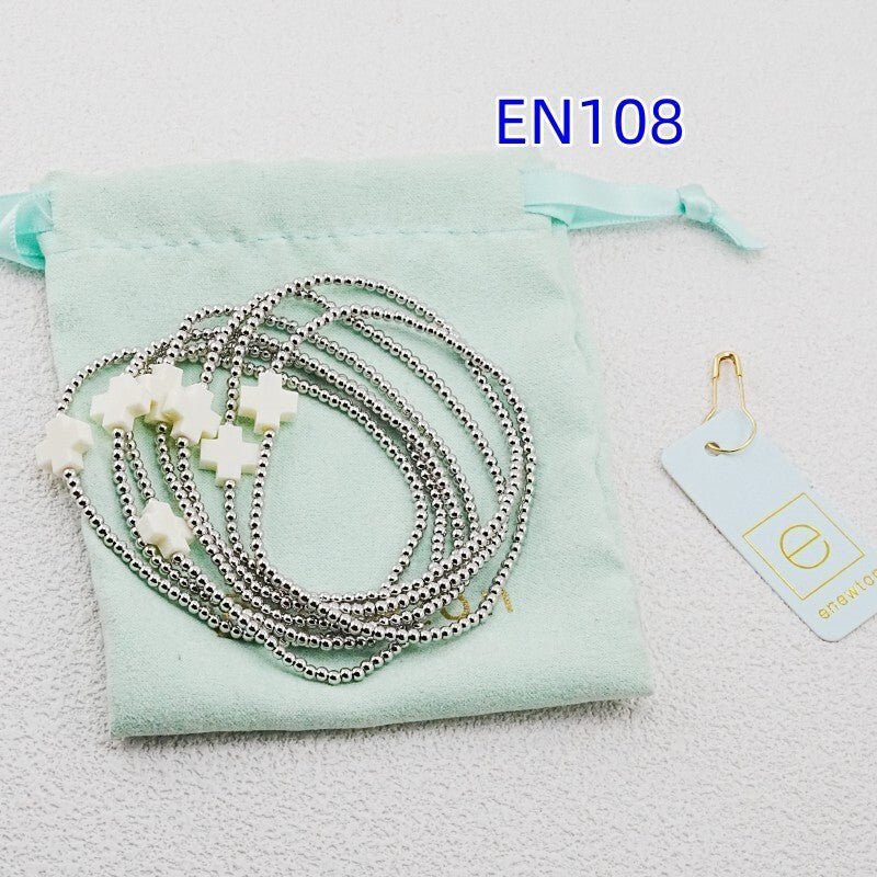 7-piece bead bracelet set with white cross charms on silver-tone chains