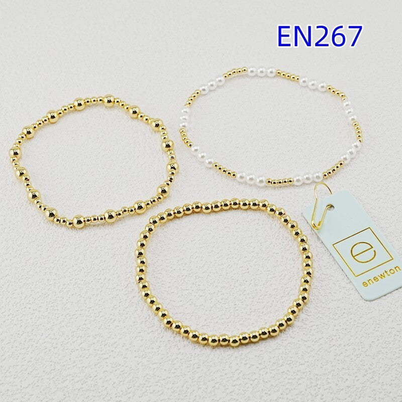 Three-piece gold bead bracelet set with white pearl detailing