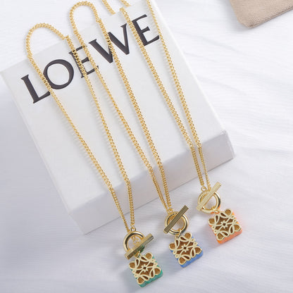 Gold-tone chain necklace with green and orange enamel square cutout logo pendants