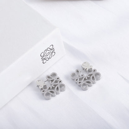 White gold geometric hollow diamond stud earrings pair with heart-like openwork pavé design