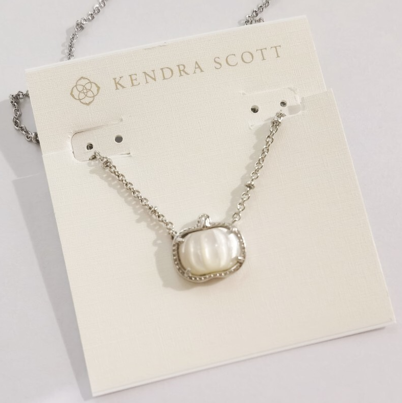 Silver necklace with white pumpkin pendant and small dangling stud earrings