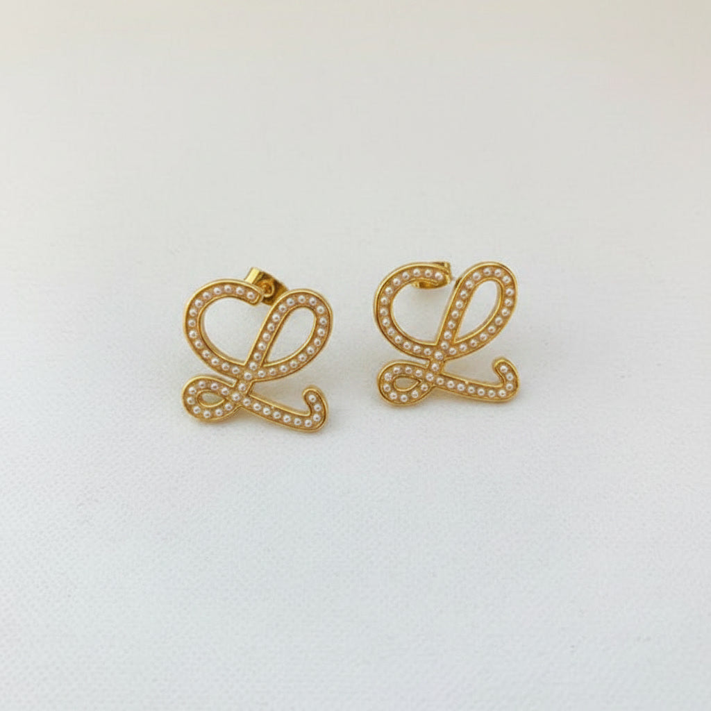 Geometric pearl-encrusted earrings, gold tone pair, stud backs visible