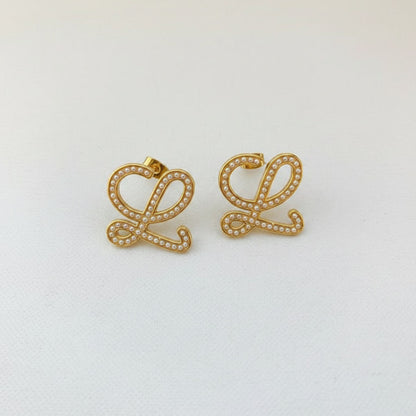 Geometric pearl-encrusted earrings, gold tone pair, stud backs visible