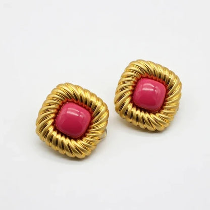 Gold-tone scalloped stud earrings with pink cabochon centers, pair