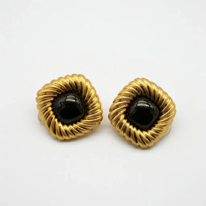 Gold-tone scalloped stud earrings with black cabochon centers, pair