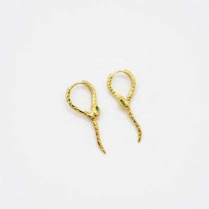 Gold-tone snake ear cuffs with green crystal accents and curved dangling ends