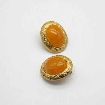 Gold-tone bezel yellow oval glass stud earrings, textured frame, minimal antique style