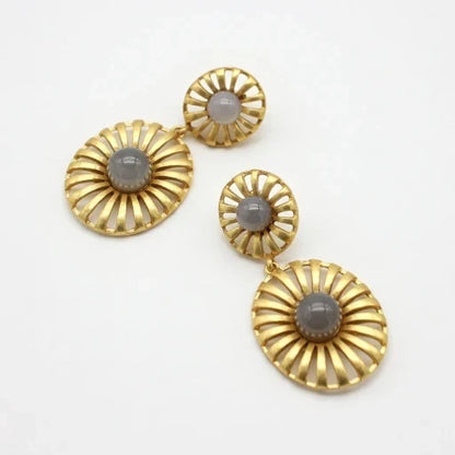 Gold-tone sunburst drop earrings with light gray cabochon discs and small top studs