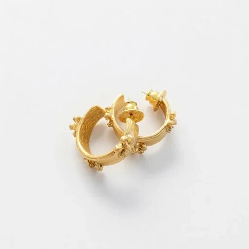 Gold-tone C hoop earrings with embossed flower accents and stud posts