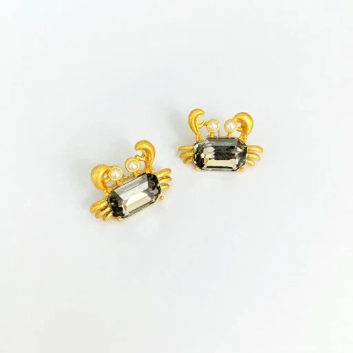 Crab-shaped crystal stud earrings with gold-tone settings, pearls, and a dark smoky gem