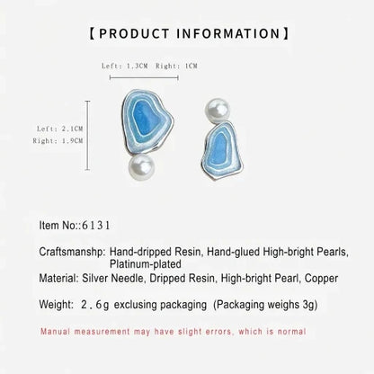Asymmetric blue enamel drop earrings with white pearls, size diagram on plain background