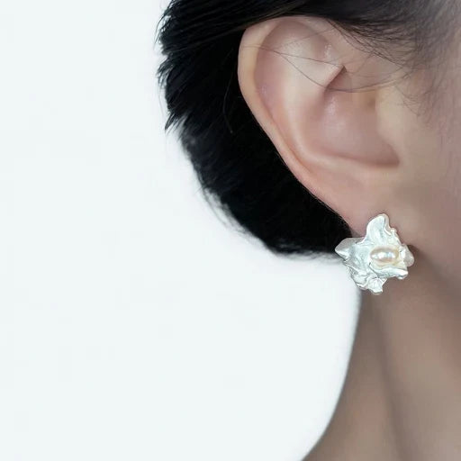 Freshwater pearl stud earring on ear, irregular sculpted silver setting
