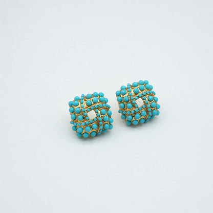 Pair of turquoise beaded stud earrings with gold-tone woven lattice center