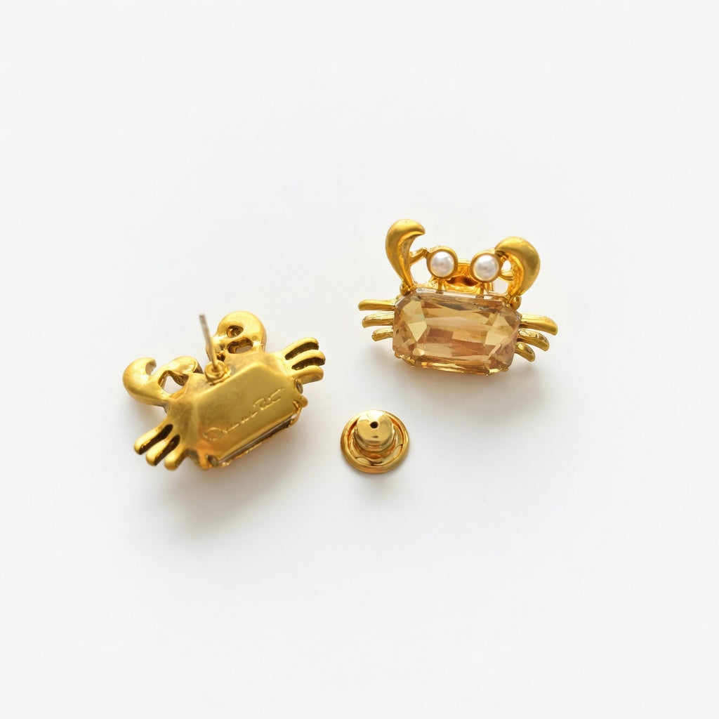 Gold-tone crab stud earring with faceted amber crystal front and screw-back post
