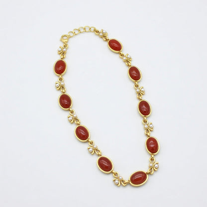 Vintage red oval glass link necklace with gold bow details and oval pendants