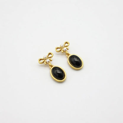 Vintage black oval glass drop earrings with gold bow tops and pearl accents