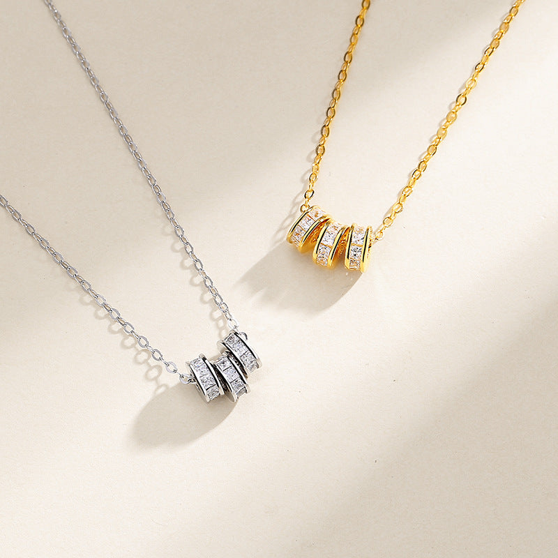 gold necklace with diamonds around it