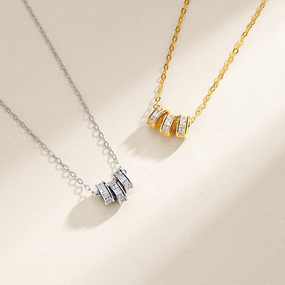 gold necklace with diamonds around it