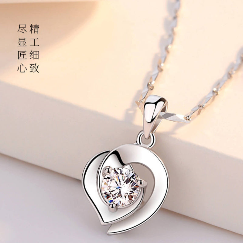heart necklace with diamond in the middle
